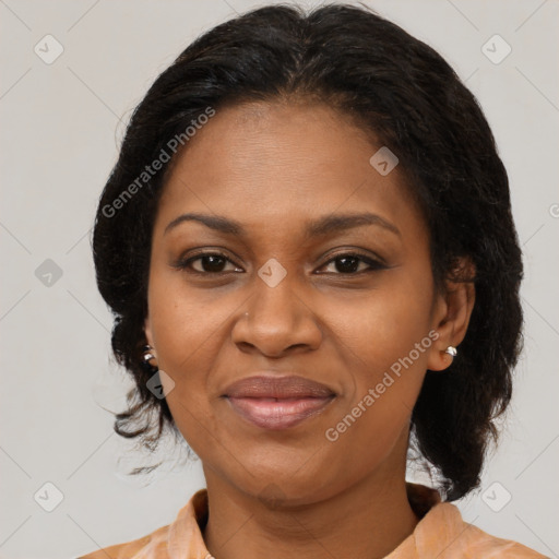 Joyful black adult female with medium  brown hair and brown eyes
