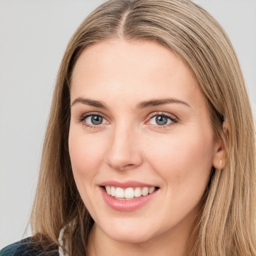 Joyful white young-adult female with long  brown hair and green eyes