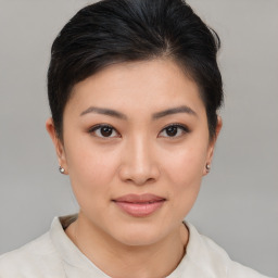 Joyful asian young-adult female with short  brown hair and brown eyes