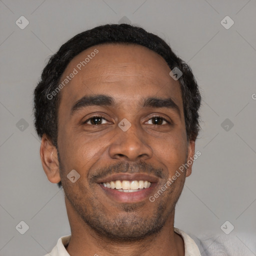 Joyful black young-adult male with short  black hair and brown eyes