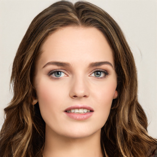 Joyful white young-adult female with long  brown hair and green eyes