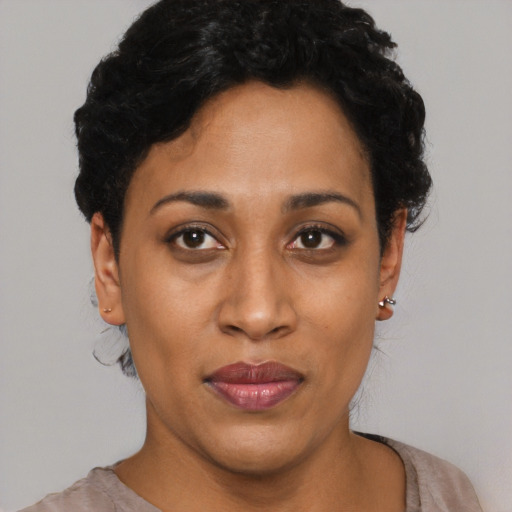 Joyful black young-adult female with short  black hair and brown eyes