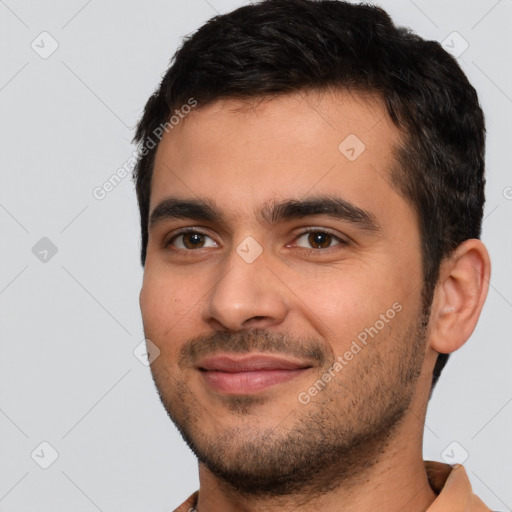 Joyful white young-adult male with short  black hair and brown eyes