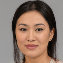 Joyful asian young-adult female with medium  brown hair and brown eyes