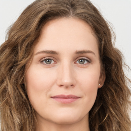 Joyful white young-adult female with long  brown hair and green eyes