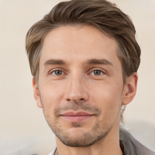 Joyful white young-adult male with short  brown hair and brown eyes