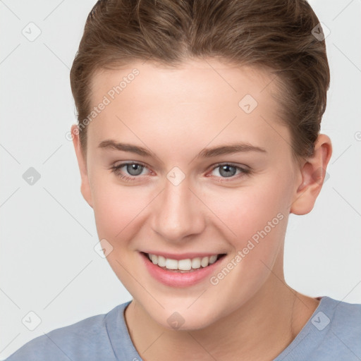 Joyful white young-adult female with short  brown hair and grey eyes