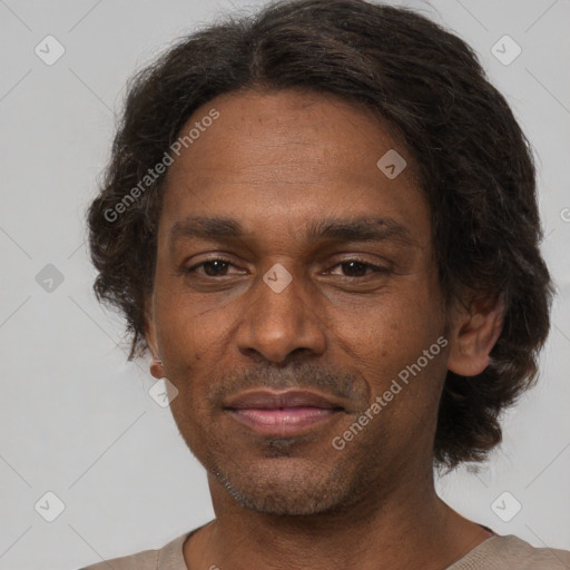 Joyful black adult male with short  brown hair and brown eyes