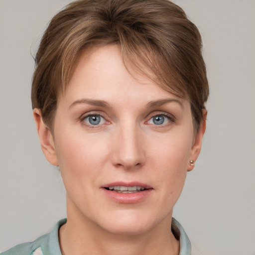 Joyful white young-adult female with short  brown hair and grey eyes