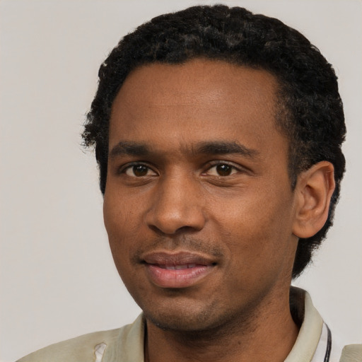 Joyful black young-adult male with short  black hair and brown eyes