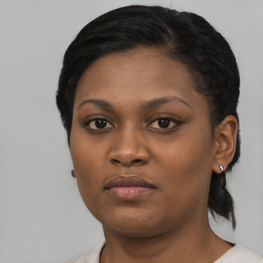 Joyful black young-adult female with short  black hair and brown eyes