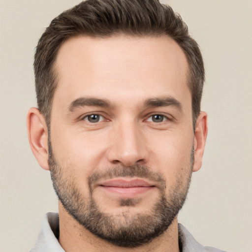 Joyful white young-adult male with short  brown hair and brown eyes