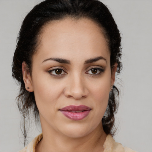 Joyful latino young-adult female with medium  brown hair and brown eyes