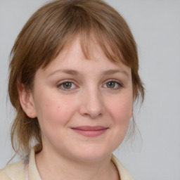 Joyful white young-adult female with medium  brown hair and blue eyes