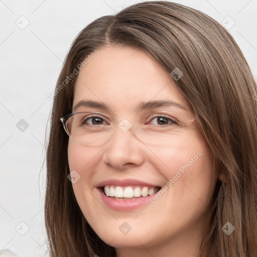 Joyful white young-adult female with long  brown hair and brown eyes