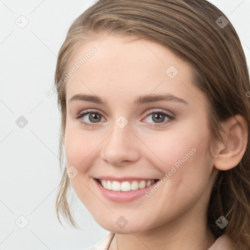 Joyful white young-adult female with long  brown hair and grey eyes