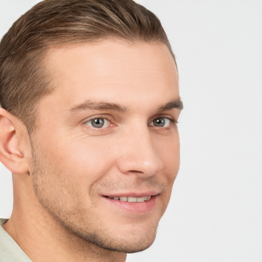 Joyful white young-adult male with short  brown hair and brown eyes