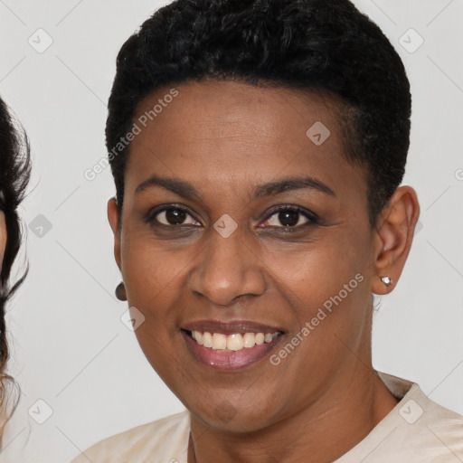 Joyful black young-adult female with short  black hair and brown eyes