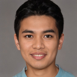 Joyful latino young-adult male with short  brown hair and brown eyes