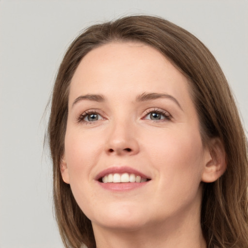 Joyful white young-adult female with long  brown hair and grey eyes