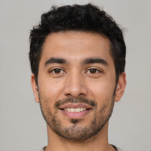 Joyful latino young-adult male with short  black hair and brown eyes
