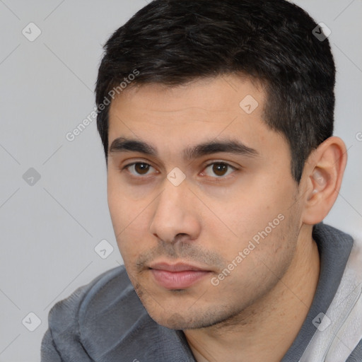 Neutral white young-adult male with short  black hair and brown eyes