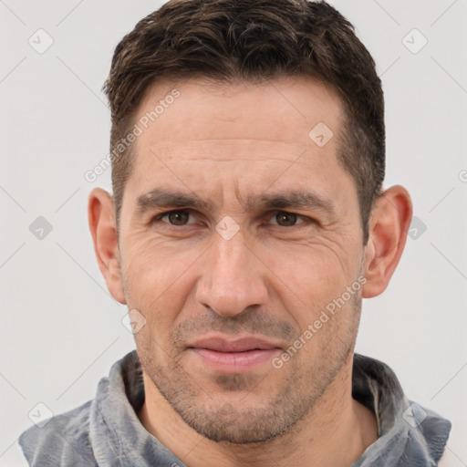 Joyful white adult male with short  brown hair and brown eyes