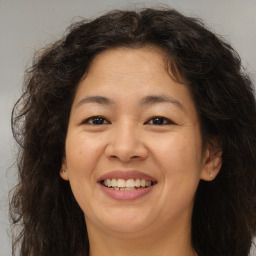 Joyful white adult female with long  brown hair and brown eyes