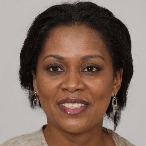 Joyful black adult female with medium  brown hair and brown eyes