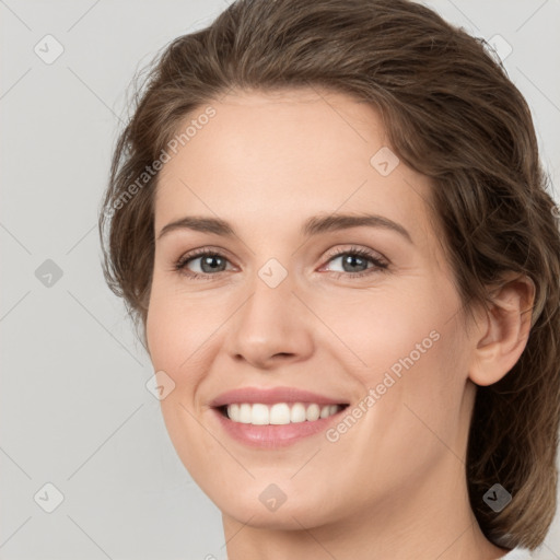 Joyful white young-adult female with medium  brown hair and green eyes