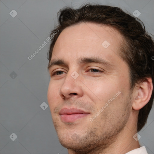 Joyful white adult male with short  brown hair and brown eyes