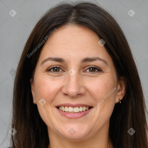Joyful white adult female with long  brown hair and brown eyes