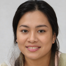 Joyful latino young-adult female with long  brown hair and brown eyes