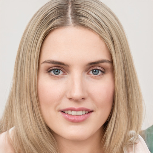 Joyful white young-adult female with long  brown hair and green eyes