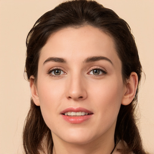 Joyful white young-adult female with long  brown hair and brown eyes