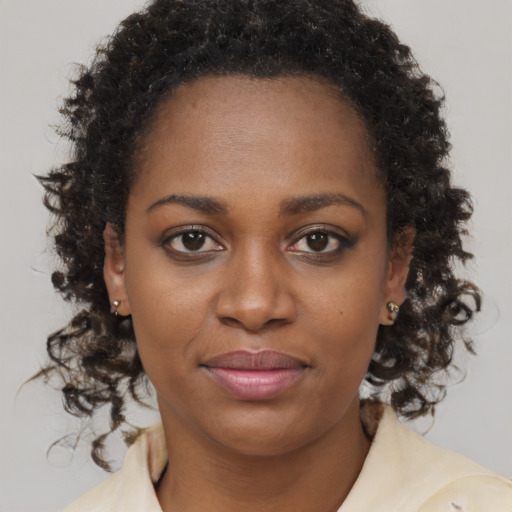 Joyful black young-adult female with medium  brown hair and brown eyes