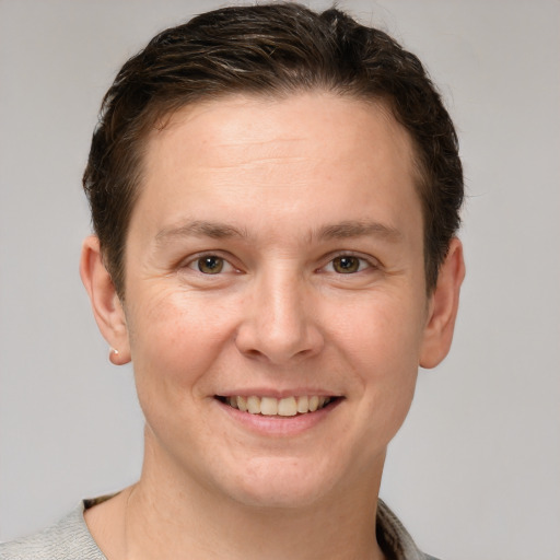 Joyful white adult male with short  brown hair and grey eyes