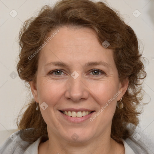 Joyful white adult female with medium  brown hair and grey eyes