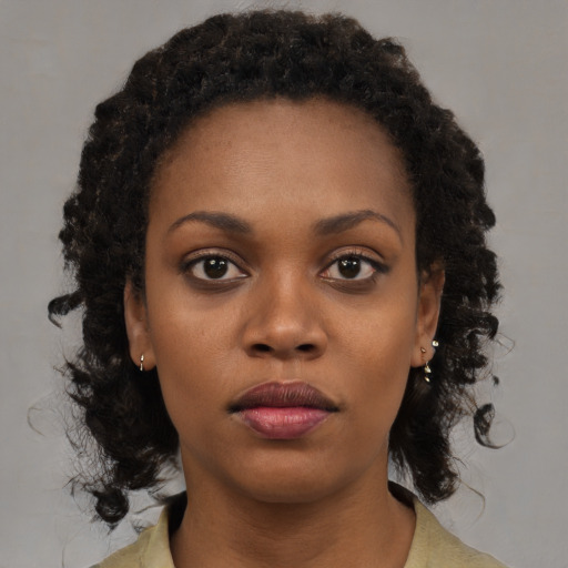 Neutral black young-adult female with medium  brown hair and brown eyes