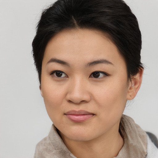 Joyful asian young-adult female with medium  brown hair and brown eyes
