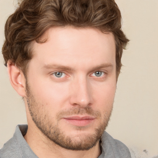 Joyful white young-adult male with short  brown hair and blue eyes