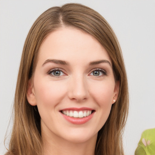 Joyful white young-adult female with long  brown hair and green eyes