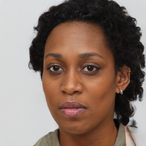 Neutral black young-adult female with long  brown hair and brown eyes