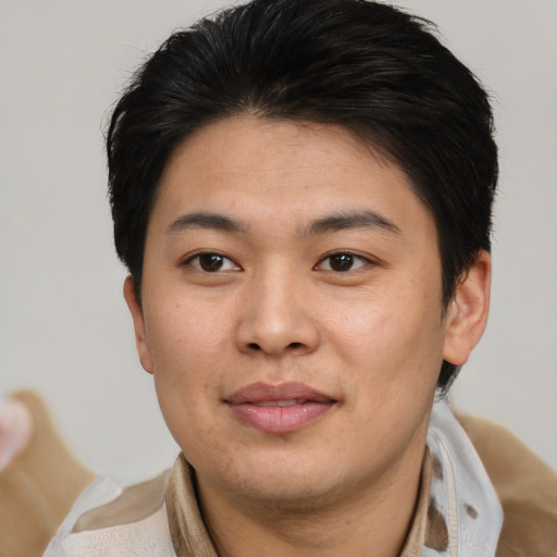 Joyful asian young-adult male with short  brown hair and brown eyes