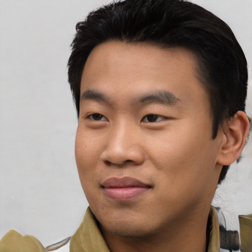 Joyful asian young-adult male with short  black hair and brown eyes