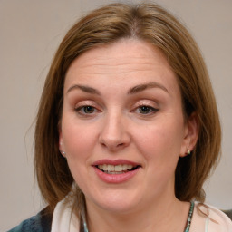 Joyful white young-adult female with medium  brown hair and blue eyes