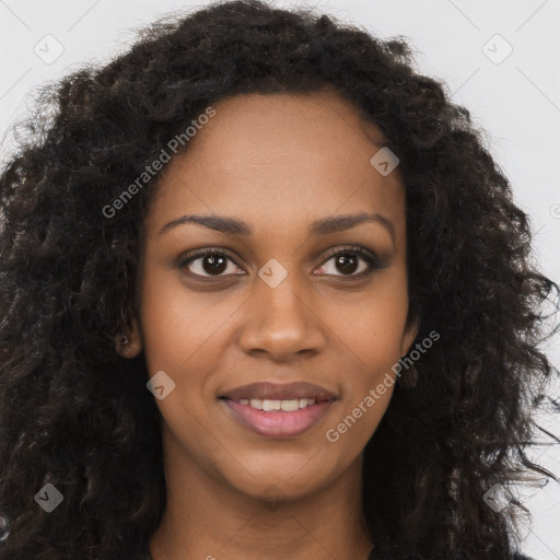 Joyful black young-adult female with long  brown hair and brown eyes