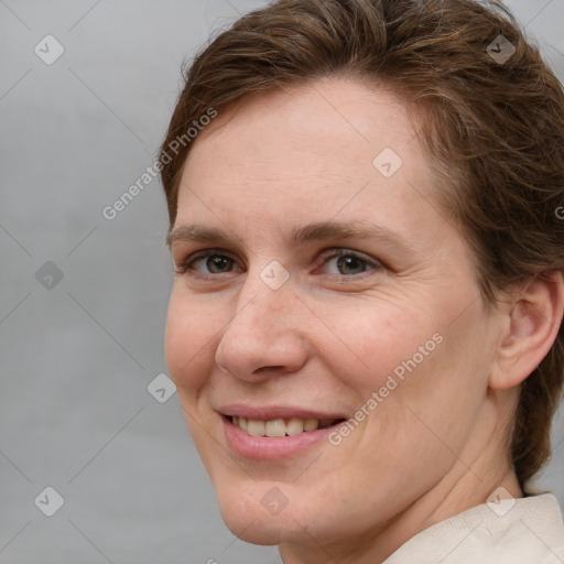 Joyful white adult female with short  brown hair and grey eyes