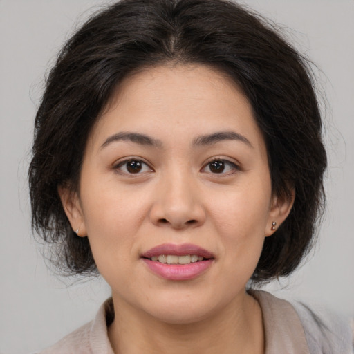 Joyful asian young-adult female with medium  brown hair and brown eyes