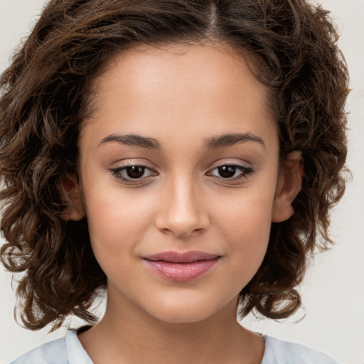 Joyful white child female with medium  brown hair and brown eyes